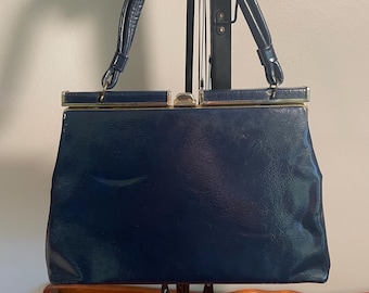 May include: A vintage navy blue handbag with gold hardware and a top handle.