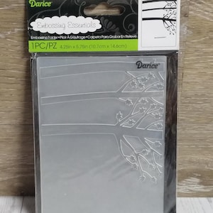 May include: A clear embossing folder with a tree branch design. The package reads "Embossing Essentials" and "Darice". The folder measures 4.25 inches by 5.75 inches.