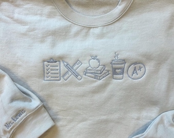 Sudadera de cuello redondo con bordado del icono del profesor y bordado en la manga.