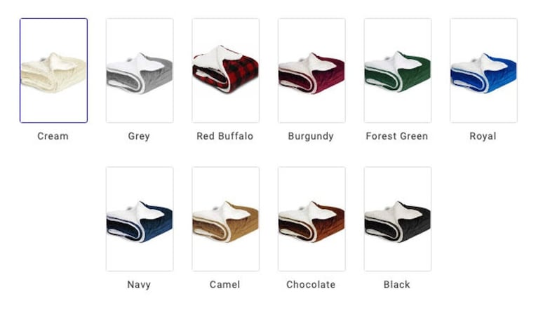 May include: A selection of plush sherpa blankets in various colors, including cream, grey, red buffalo plaid, burgundy, forest green, royal blue, navy, camel, chocolate, and black. Each blanket features a white sherpa lining.