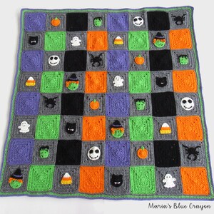 May include: A crocheted Halloween blanket with a checkerboard pattern in green, orange, gray, and black. The squares feature various Halloween-themed appliques, including ghosts, pumpkins, witches, bats, candy corn, and a skull.