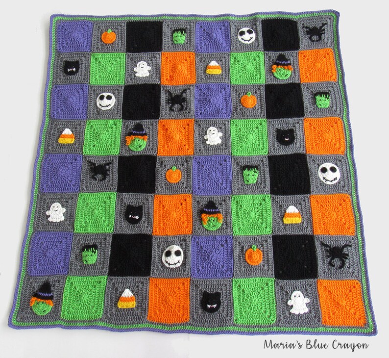 May include: A crocheted Halloween blanket with a checkerboard pattern in green, orange, gray, and black. The squares feature various Halloween-themed appliques, including ghosts, pumpkins, witches, bats, candy corn, and a skull.