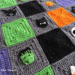 May include: A crocheted Halloween blanket with squares featuring various Halloween characters, including a ghost, a spider, a black cat, a pumpkin, a witch, a Frankenstein, a candy corn, and a Jack Skellington. The blanket is made with different colored yarn, including gray, green, orange, purple, black, and white.