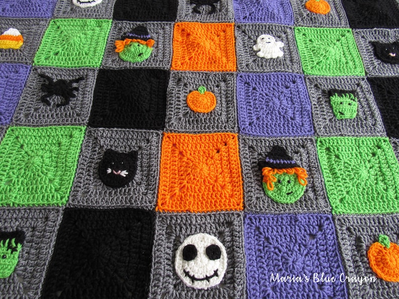 May include: A crocheted Halloween blanket with squares in green, orange, gray, black, and purple. Each square features a different Halloween character, including a witch, a ghost, a pumpkin, a cat, a spider, a Frankenstein, and a Jack Skellington.