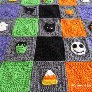 May include: A crocheted Halloween blanket with squares featuring various Halloween characters, including a ghost, a spider, a pumpkin, a cat, a witch, a monster, a skull, and a candy corn. The blanket is made with different colored yarn, including purple, green, orange, black, and gray.