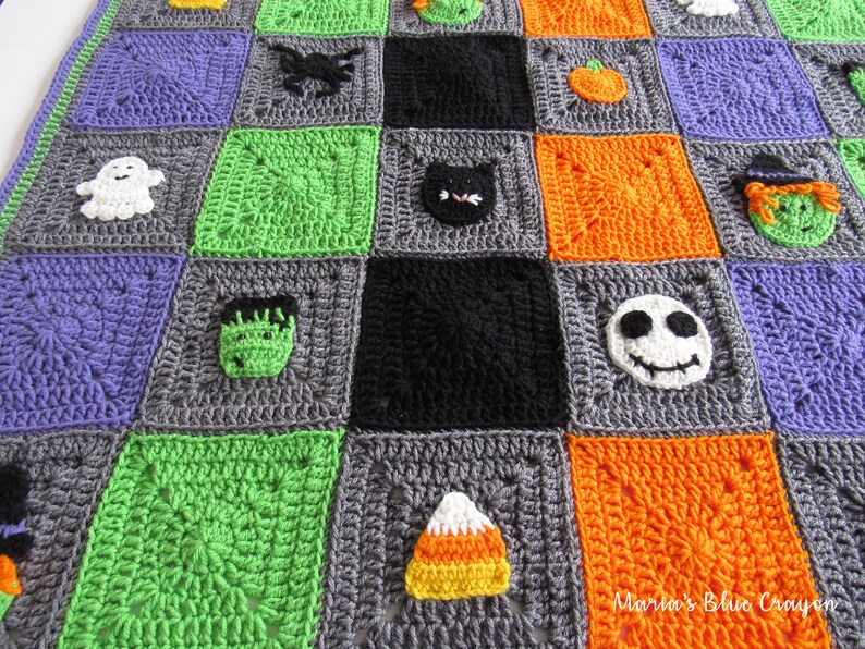 May include: A crocheted Halloween blanket with squares featuring various Halloween characters, including a ghost, a spider, a pumpkin, a cat, a witch, a monster, a skull, and a candy corn. The blanket is made with different colored yarn, including purple, green, orange, black, and gray.