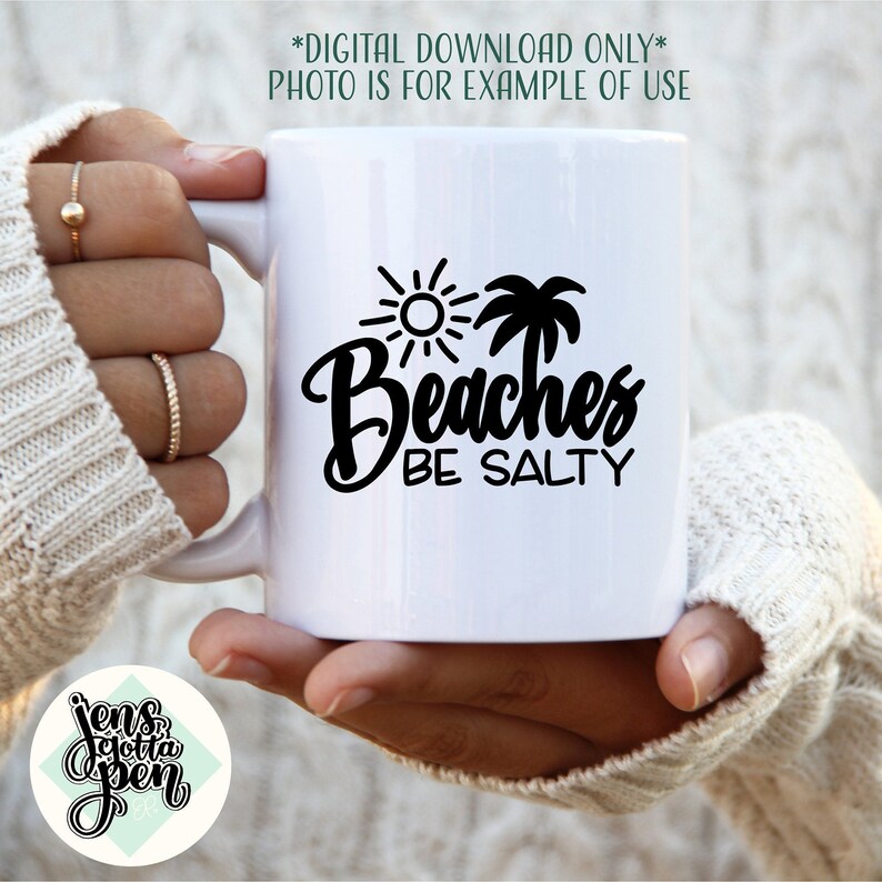 May include: White ceramic mug with a black graphic of a palm tree, sun, and the text "Beaches Be Salty".