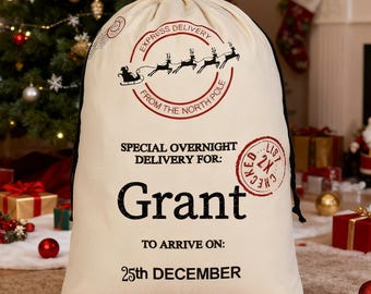 May include: A cream-coloured Christmas gift sack with black text that reads "Express Delivery From The North Pole" and "Special Overnight Delivery For: Grant". The sack is decorated with a Santa and reindeer graphic and a red stamp.
