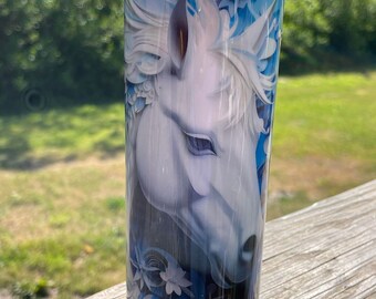 May include: A white horse head with blue floral designs on a stainless steel tumbler.