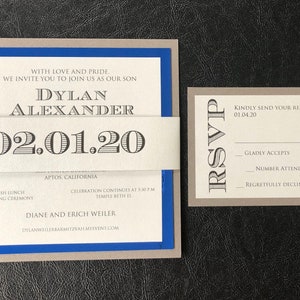 May include: A grey and blue invitation card with a white band. The card reads "With love and pride, we invite you to join us as our son Dylan Alexander 02.01.20 Aptos, California Kiddush lunch following ceremony Celebration continues at 5:30 pm Temple Beth El Diane and Erich Weiler Dylanweilerbarmitzvahmyevent.com". A separate grey card reads "RSVP Kindly send your response by 01.04.20 Gladly accepts Number attending Regretfully declines".