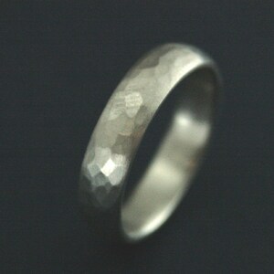 May include: A silver hammered wedding band.