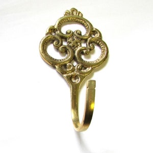 Filigree Swirl Brass J- Hook, 2-1/4" w x 3"h (approx.)  Decorative hanging accent for your Home.