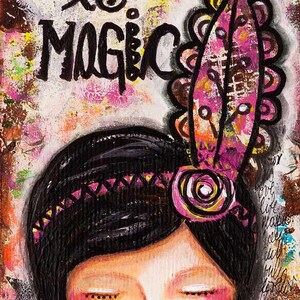 May include: A colorful painting of a woman with closed eyes and a pink flower in her hair. The text "Life is Magic" is written in black paint above her head.