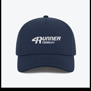 May include: A navy blue baseball cap with the text "4Runner OGSUV" in white. The cap has a curved brim and a small button on top. The sides of the cap have small ventilation holes.