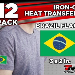 May include: A pack of 12 iron-on heat transfers featuring the Brazilian flag. Each transfer is 3 inches by 2 inches. The transfers are shown on a gray t-shirt.