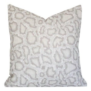 May include: A white and gray patterned throw pillow with a subtle snakeskin design.
