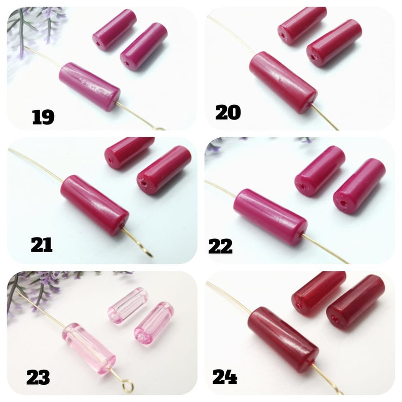 May include: Assortment of pink and red glass beads for jewelry making. The beads are cylindrical and have a smooth, glossy finish. The beads are arranged in groups of two or three on a white background.