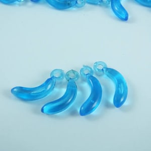 May include: Five blue plastic banana-shaped charms with a small loop at the top of each charm.