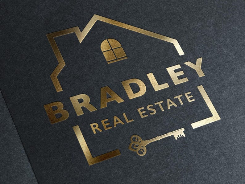 A gold foil logo on a dark gray background, showing a house outline, the text "BRADLEY REAL ESTATE," and a vintage key.