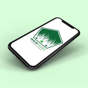 A smartphone displaying a white screen with a green pentagonal logo featuring grass, three stars, and "MOWMORE LANDSCAPING" text, on a light green background.