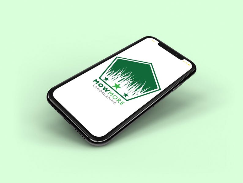 A smartphone displaying a white screen with a green pentagonal logo featuring grass, three stars, and "MOWMORE LANDSCAPING" text, on a light green background.