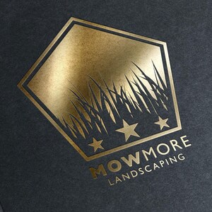 A gold foil-stamped pentagonal logo with grass, three stars, and "MOWMORE LANDSCAPING" text on a dark gray textured background.
