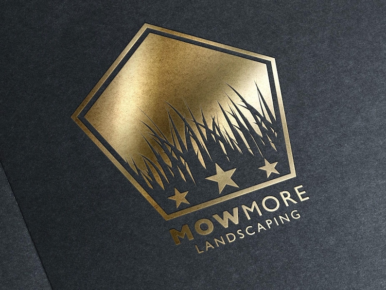 A gold foil-stamped pentagonal logo with grass, three stars, and "MOWMORE LANDSCAPING" text on a dark gray textured background.