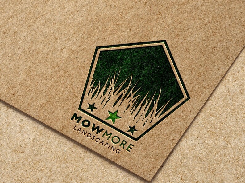 A pentagonal logo with green grass, three green stars, and "MOWMORE LANDSCAPING" text printed on a brown paper background.