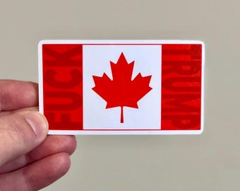 May include: A red, white, and red sticker with a Canadian flag design. The sticker says "FUCK TRUMP" in red letters.