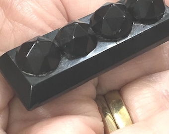 S4 An antique Victorian Whitby Jet mourning brooch with simple C clasp and overlong pin.
