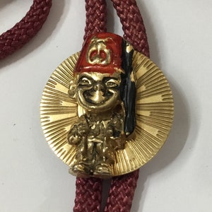 K9 Vintage Shriners (Masonic link) Bolo with bullet tipped fabric cord. Dating from 60/70’s, Originally from the USA. Tracked shipping.