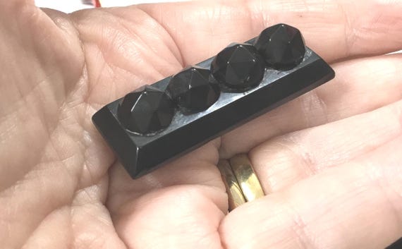 S4 An antique Victorian Whitby Jet mourning brooch with simple C clasp and overlong pin.