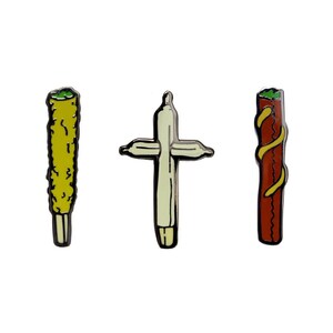 May include: Three enamel pins depicting a joint, a joint shaped like a cross, and a joint with a red and yellow swirl pattern.
