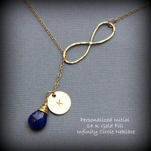 May include: Gold infinity circle necklace with a small round charm with the letter K and a blue gemstone pendant.  Personalized Initial 14K Gold Fill Infinity Circle Necklace.