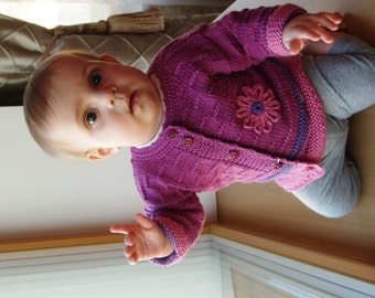 Hand knit Merino wool sweater / cardigan in orchid purple witha flower. Sizes 0-7 years