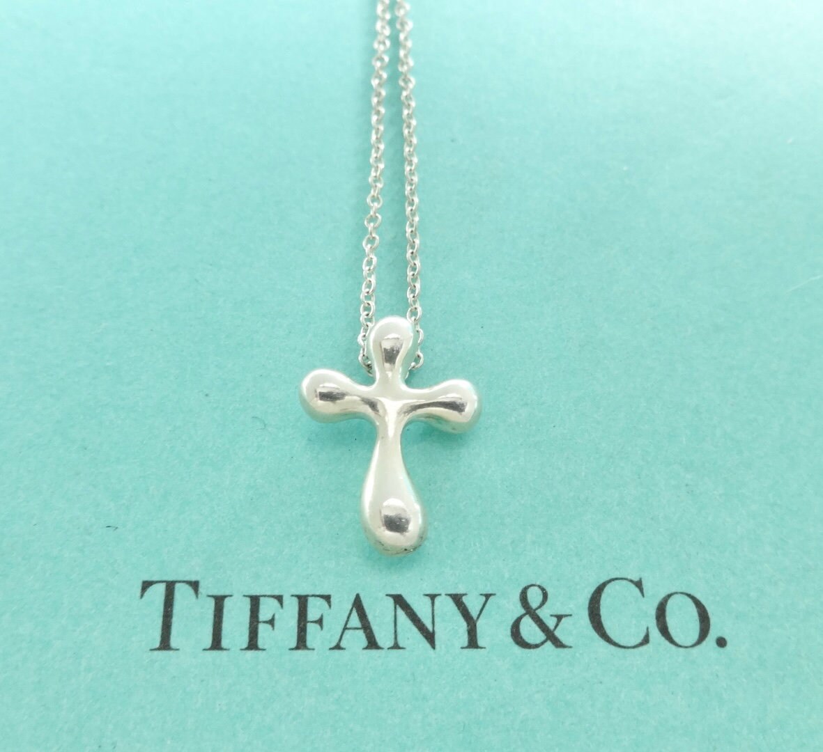 Tiffany concave store cross pendant