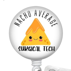 May include: A white retractable badge reel with a "Nacho Average Surgical Tech" design. The design features a smiling cartoon nacho chip with orange cheese and the text "Nacho Average" and "Surgical Tech" in black.