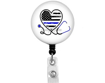 May include: A white badge reel with a black retractable cord and a clear plastic clip. The badge holder features a distressed American flag heart with a blue line across the middle and a stethoscope.