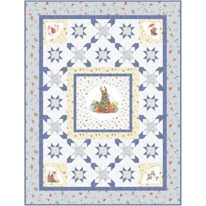 May include: A blue and white quilt with a central square featuring a rabbit surrounded by vegetables. The quilt is made up of a repeating pattern of stars and is bordered with a floral print.