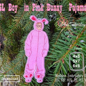 May include: A pink bunny costume with a boy's face and glasses. The costume is on a green tree branch. The text "FSL Boy in Pink Bunny Pajamas" is at the top of the image. The text "ArtEmbroidery" is in the upper right corner of the image. The text "Digital Download" is in the lower left corner of the image. The text "* 3 sizes" is in the middle right of the image. The text "4x6", "5x7", and "6x8" are in a box in the middle right of the image. The text "Machine Embroidery Designs" is below the box. The text "OST, EXP, HUS, JEF, PES, VP3, XXX" is below the text "Machine Embroidery Designs".