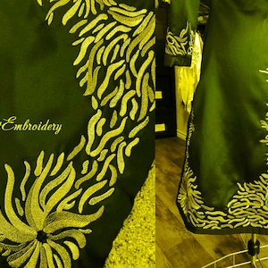 May include: A dark green garment with gold embroidery. The embroidery is a floral design with a repeating pattern. The garment is on a mannequin.