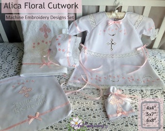 May include: A set of white embroidery designs for a baby christening. The set includes a gown, a bonnet, a towel, a burp cloth, and a small bag. The designs feature a cross and floral motifs in pink.