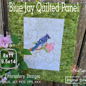 May include: A quilted panel featuring a blue jay perched on a branch with a pink flower, set against a white background with gold swirling patterns and a green border. Text includes Blue Jay Quilted Panel, 8x11, 9.5x14, and Machine Embroidery Designs.