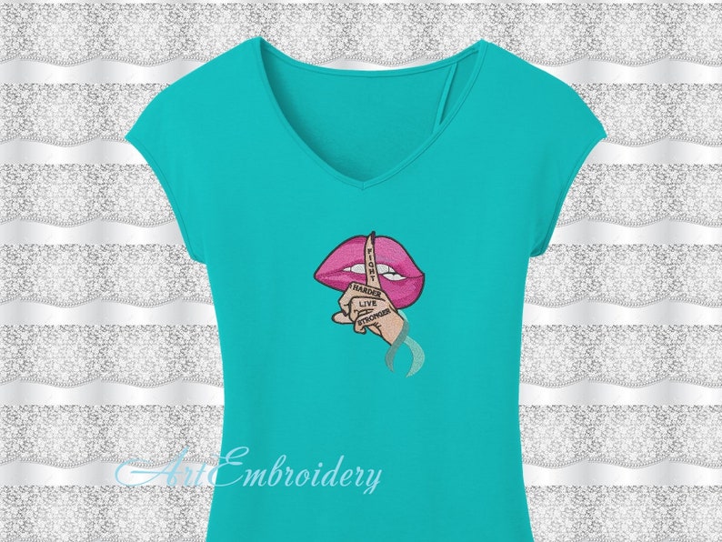 May include: A turquoise t-shirt with an embroidered design of a pink mouth with a finger over it. The finger has the words "Fight Harder Live Stronger" written on it.