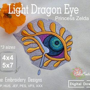 May include: Embroidered design of a light dragon eye with yellow, purple, and blue details. The text "Light Dragon Eye Princess Zelda" is above the design. Includes text for sizes and "Machine Embroidery Designs".