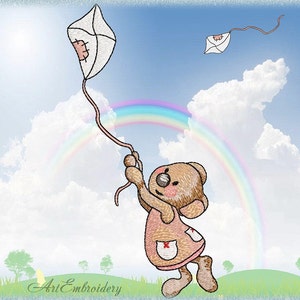 May include: An embroidered image of a teddy bear in a pink dress flying a white kite with a pink string against a blue sky with clouds and a rainbow. The bear has a red cross on its dress pocket. The text "Art Embroidery" is at the bottom.
