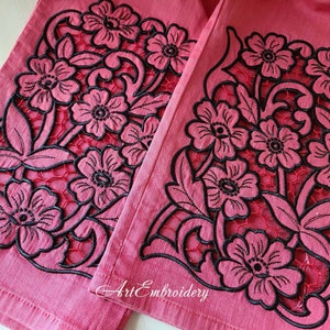May include: Two pieces of pink fabric with black embroidered floral designs. The fabric has a delicate, lacy look with cut-out details. The text "Art Embroidery" is visible in the bottom right corner.