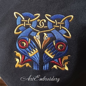 May include: Embroidered design of two stylized birds with blue, red, and gold thread on a dark blue fabric. The design is in a Celtic knot style. The text "Art Embroidery" is visible at the bottom of the image.