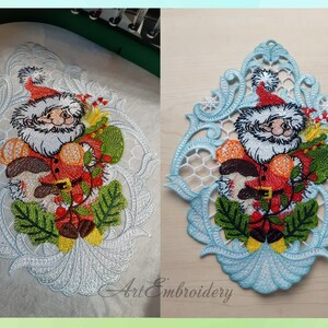 May include: A white lace design with a blue background featuring a cartoon Santa Claus holding a bag of gifts and a candy cane. The design is perfect for a Christmas ornament or decoration.