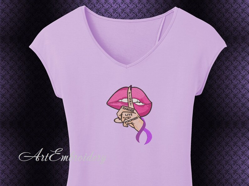 May include: Purple t-shirt with a pink lips design and a finger over the lips. The finger has the words "Fight Harder Live Stronger" written on it.